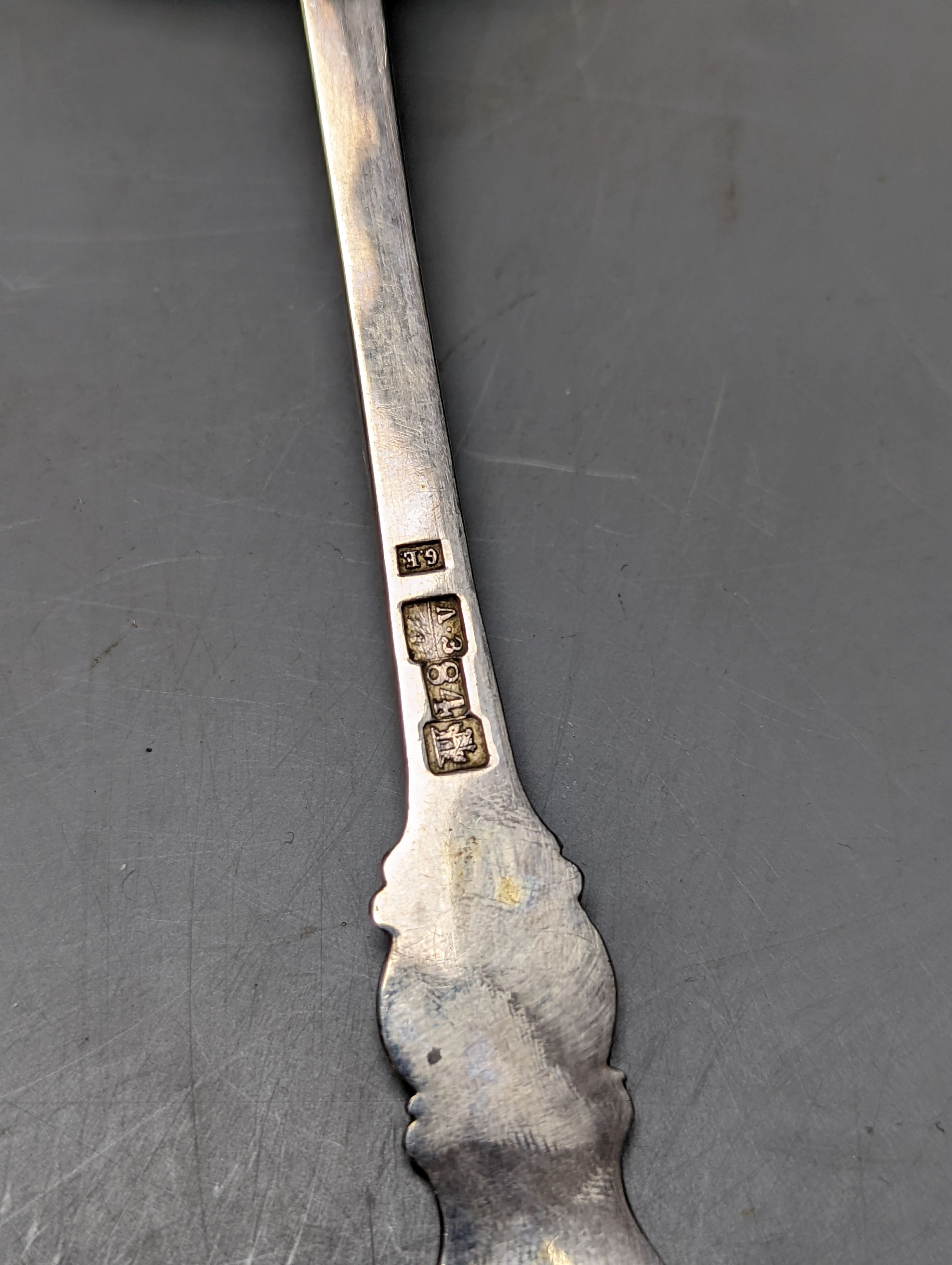 A late 19ty century Russian 84 zolotnik sifter ladle, assay master Ludvig Zug, 187?, 18.7cm, and a Victorian silver sifter spoon with vineous handle, 5oz.